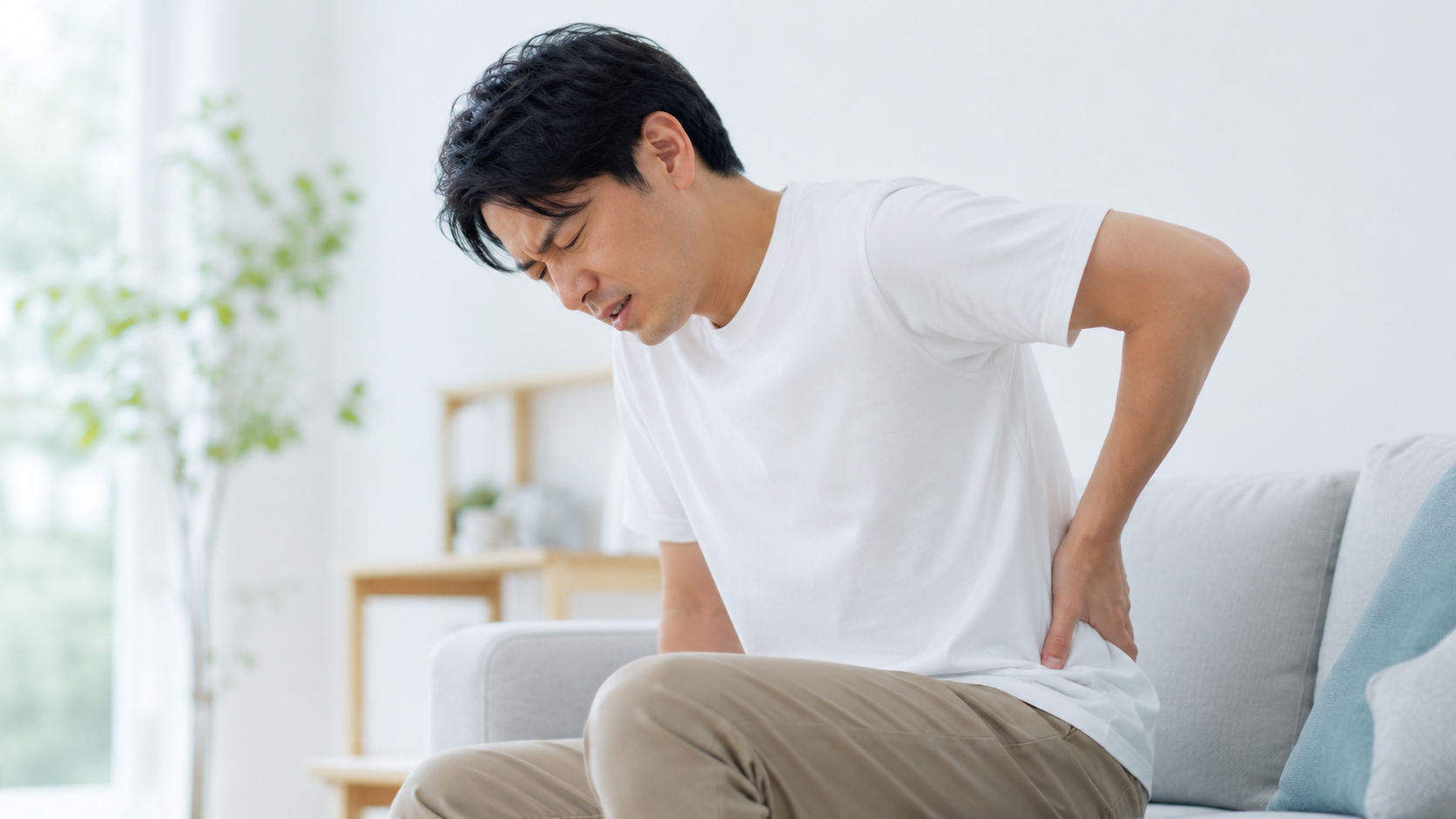 デスクワーク中に腰痛に悩む30代男性